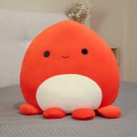 Plüsch Oktopus weiches orangefarbenes Kissen auf einem Bett