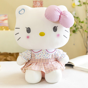 Hello Kitty Plüschtier, das vor einem Buch sitzt